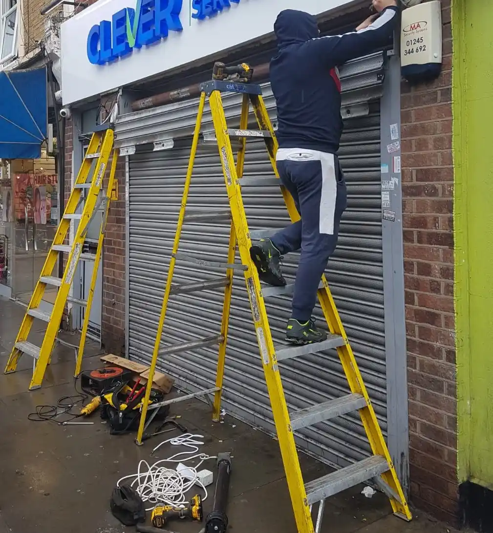 Roller shutter repair technician working
